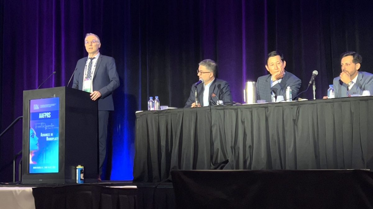Dr George Mireas speaking during an international facial plastic surgery symposium panel discussion