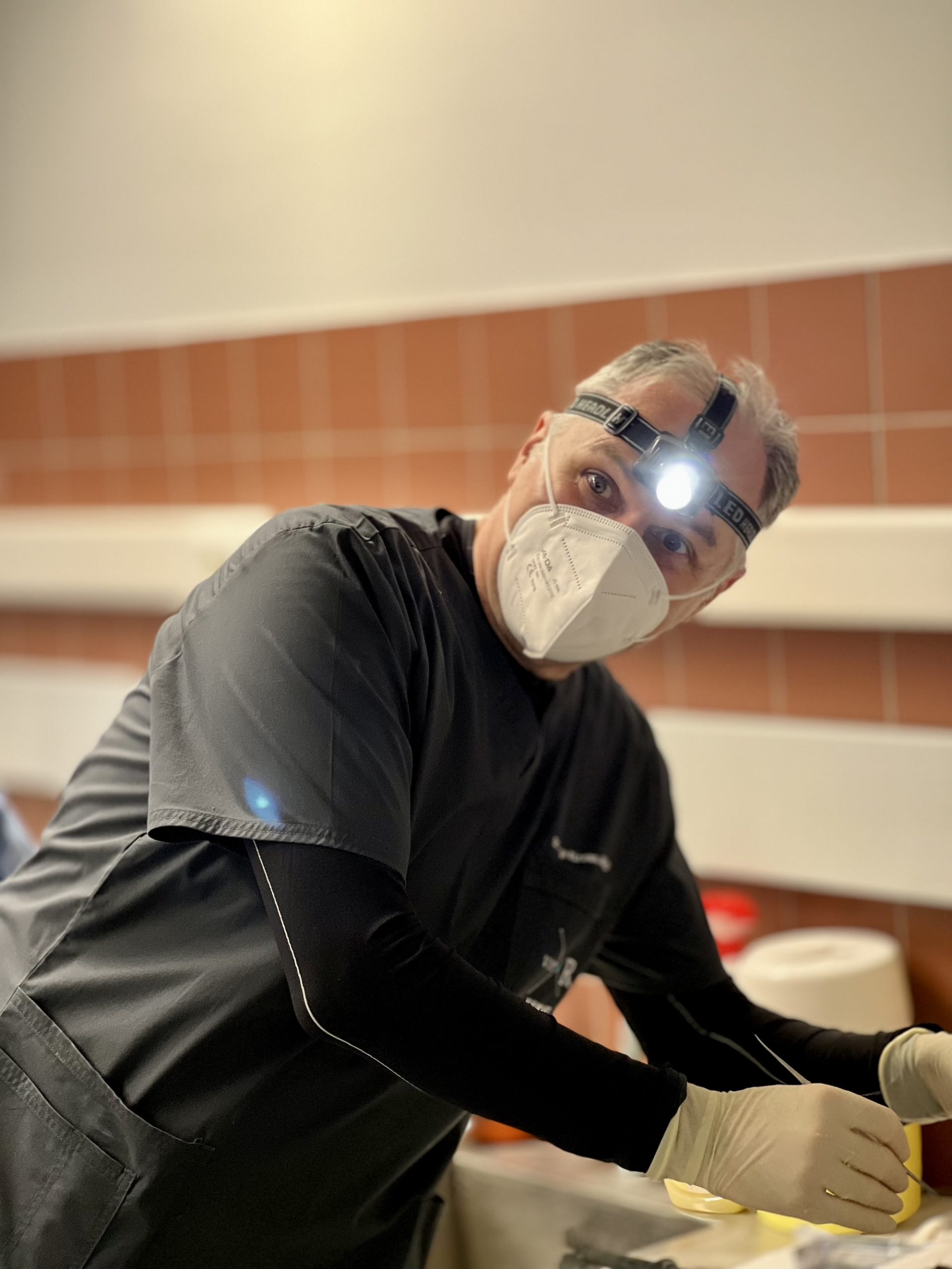 Dr George Mireas during hands-on teaching preparation at the University of Patras rhinoplasty fresh cadaver workshop in 2022